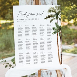 May include: A white wedding seating chart with a tropical theme. The chart features a handwritten title "Find your seat" and the names "Olivia & Theodore" with the date "June 19th, 2023". The chart lists table numbers and guest names.