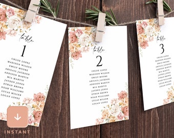 May include: Three table cards with floral designs and table numbers 1, 2, and 3. Each card lists a set of names for a wedding reception seating chart.