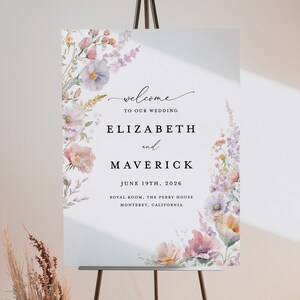 May include: A wedding welcome sign with a watercolor floral design in shades of pink, purple, and yellow. The sign reads "Welcome to our wedding, Elizabeth and Maverick, June 19th, 2026, Royal Room, The Perry House, Monterey, California."
