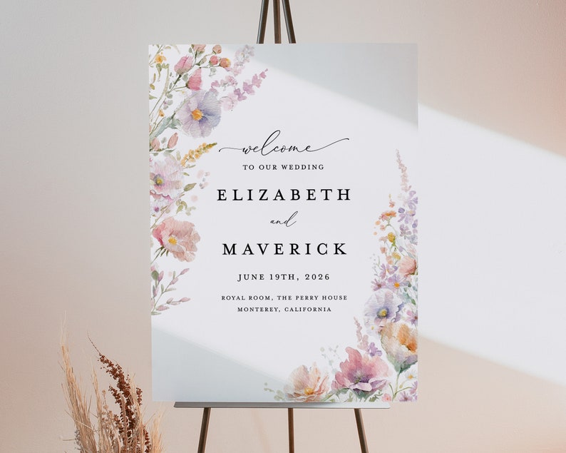 May include: A wedding welcome sign with a watercolor floral design in shades of pink, purple, and yellow. The sign reads "Welcome to our wedding, Elizabeth and Maverick, June 19th, 2026, Royal Room, The Perry House, Monterey, California."