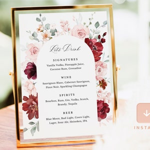 May include: A printable wedding sign with a floral design in shades of pink, red, and green. The sign says "Let's Drink" and lists the drinks available at the wedding reception, including signatures, wine, spirits, and beer.