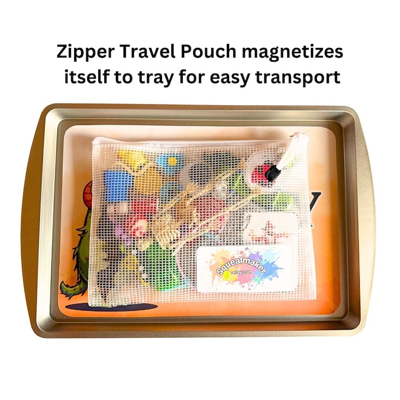 May include: A clear mesh zipper pouch filled with colourful toys and accessories sits inside a gold-coloured metal tray. The text "Zipper Travel Pouch magnetizes itself to tray for easy transport" is at the top.