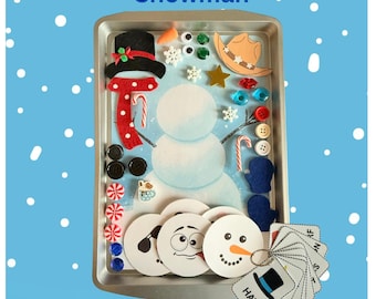 May include: A metal tray containing a snowman activity set with a printed snowman base, felt hat, scarf, buttons, googly eyes, and various decorative accessories. Includes a set of 10 picture cards labeled with text like HAT.
