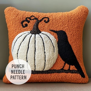 May include: Orange throw pillow with a white pumpkin and a black bird design. The pillow is made with a punch needle technique and has the text "Punch Needle Pattern" on the bottom left corner.