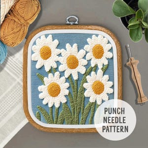 May include: A punch needle pattern featuring a blue background with five white daisies with yellow centers. The pattern is framed in a wooden hoop and the text "PUNCH NEEDLE PATTERN" is printed below the hoop.