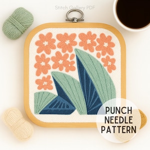 May include: A square wooden embroidery hoop with a floral punch needle pattern. The design features peach-colored flowers and blue-green leaves. The text "PUNCH NEEDLE PATTERN" is in a white circle. Two balls of yarn and a cup of coffee are also in the image.