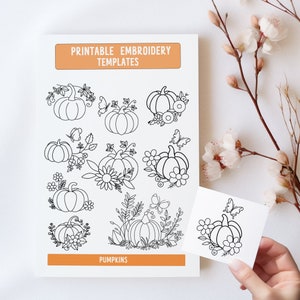 May include: Printable embroidery templates featuring nine different pumpkin designs with floral and butterfly accents. The designs are black and white and labeled "Pumpkins".