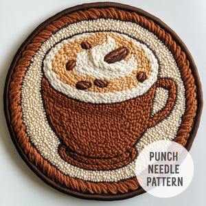 May include: A brown and white punch needle pattern of a cup of coffee with a swirl of cream on top. The text "Punch Needle Pattern" is in the lower right corner of the image.