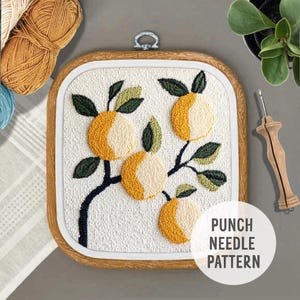 May include: A punch needle pattern featuring a branch with four oranges and green leaves. The pattern is framed in a wooden hoop and the text "Punch Needle Pattern" is visible in the bottom right corner.
