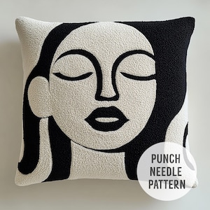 Puede incluir: Almohada de punto de aguja negra y blanca con un rostro estilizado con los ojos cerrados. El texto "Punch Needle Pattern" es visible en la esquina inferior derecha de la imagen.