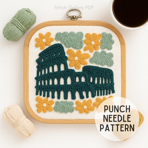 May include: A punch needle pattern featuring the Colosseum in dark teal, surrounded by yellow flowers and green cloud-like shapes. The design is set in a square wooden hoop with the text "PUNCH NEEDLE PATTERN". Two yarn skeins and a cup of coffee are also visible.