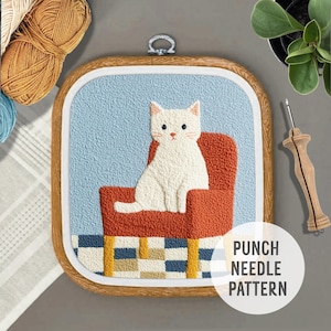 May include: A white cat sitting on a red chair with a blue and white checkered floor. The image is in a wooden frame with the text "Punch Needle Pattern" in the bottom right corner.