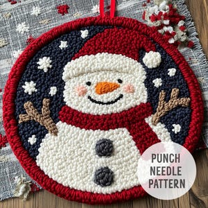May include: A punch needle pattern featuring a snowman with a red hat and scarf, holding a twig in a snowy blue background. The text "PUNCH NEEDLE PATTERN" is in the bottom right corner.