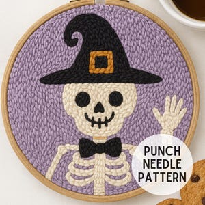 May include: A punch needle pattern featuring a friendly skeleton wearing a black witch hat with a gold buckle and a black bow tie. The skeleton is set against a lavender background within a wooden embroidery hoop. The text "PUNCH NEEDLE PATTERN" is in a white circle.