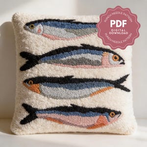 May include: A cream-colored, square throw pillow with a punch needle design of four stylized fish. The fish have black, blue, gray, and pink details. The pillow has a textured, looped surface. A pink badge reads "PDF DIGITAL DOWNLOAD".