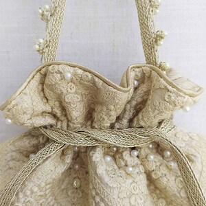 AMYRA Oyster Beige Pearl Embroidered Silk Potli bag