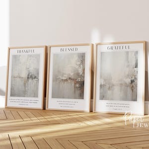 May include: Three framed prints featuring abstract watercolour paintings in shades of grey and brown. The prints have the words "Thankful", "Blessed", and "Grateful" at the top and include Bible verses below the paintings.