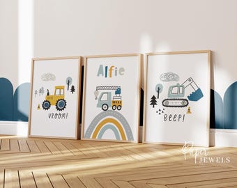 May include: Three framed wall art prints featuring construction vehicles in muted tones. The left print shows a yellow tractor with the text VROOM!. The center print displays a crane truck over a rainbow with the name Alfie. The right print shows a blue excavator with the text BEEP!.
