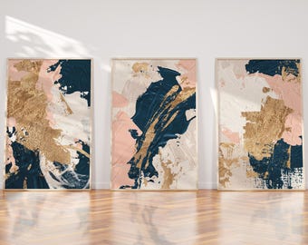 May include: Three abstract paintings with a modern, minimalist design. The paintings feature a combination of pink, white, gold, and blue colours in a layered, textured style.
