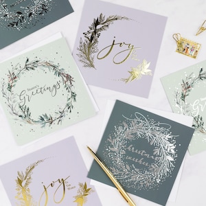 Pack of 6 square luxury Christmas cards with gold foil hand-lettered messages – Seasons Greetings, Joy to the World, and Christmas Wishes, with envelopes.
