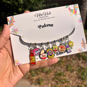 May include: A silver-toned snake chain bracelet featuring eight colorful enamel charms depicting various snack and character icons, including a hot sauce bottle, gum pack, chocolate egg, soda can, popsicle, candy, cleaner bottle, and Tweety Bird.
