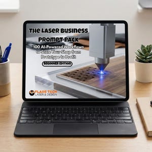 May include: A tablet displays "The Laser Business Prompt Pack" with 100 AI-powered workflows. The screen shows a laser engraving wood. A keyboard, pens, a succulent, and a notebook are on a wooden desk.