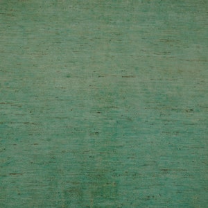 May include: A close-up of a textured green surface with a subtle wood grain pattern.