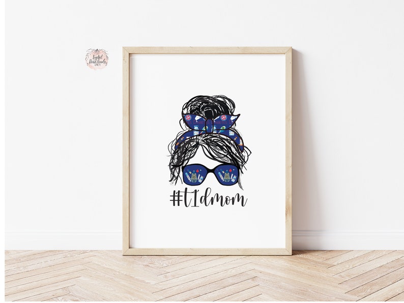 May include: A black and white illustration of a woman with a messy bun and sunglasses. The sunglasses have a pattern of medical supplies inside. The text #TIDmom is below the illustration.