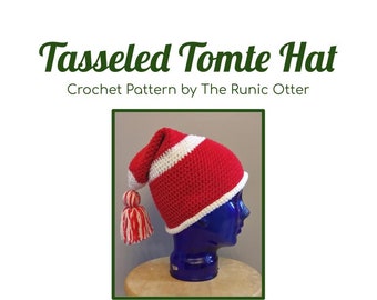 Könnte beinhalten: Eine rot-weiße gehäkelte Tomte-Mütze mit einem weißen Bommel. Die Mütze sitzt auf einem blauen Mannequin-Kopf. Der Text "Tassel Tomte Hat" und "Crochet Pattern by The Runic Otter" ist sichtbar.