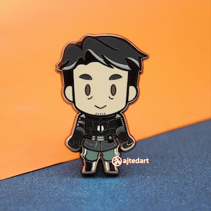 May include: A black and white enamel pin of a cartoon character wearing a black jacket and pants. The character has brown hair and a mustache. The pin is about 2 inches tall.