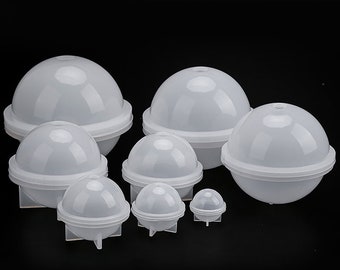 May include: Set of seven white plastic sphere moulds of varying sizes. The moulds are designed to create round, hollow objects.