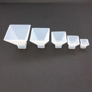 May include: Set of six white silicone pyramid-shaped molds of varying sizes.