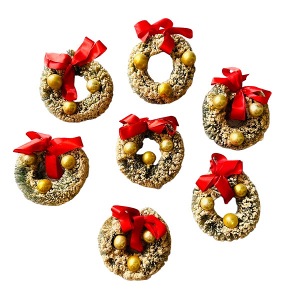 Vintage and an excellent condition set of 7 flocked forest green bottle brush wreaths With little red bows and golden balls.