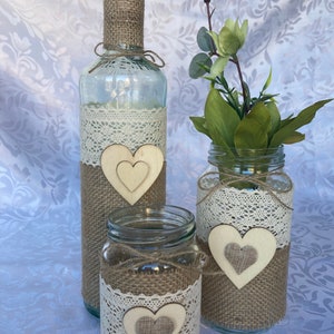 Wedding table decoration of three rustic items. Rustic bottle and jars