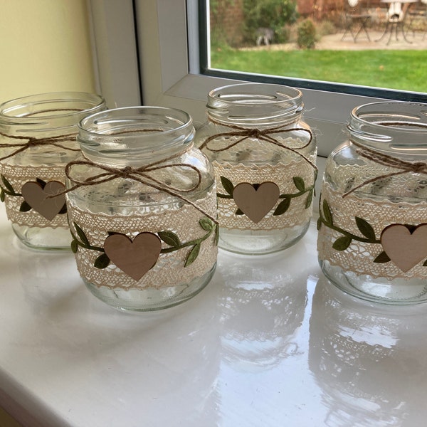 Set of lace and sage green decorated jars ideal for wedding table table decor or party decorations.