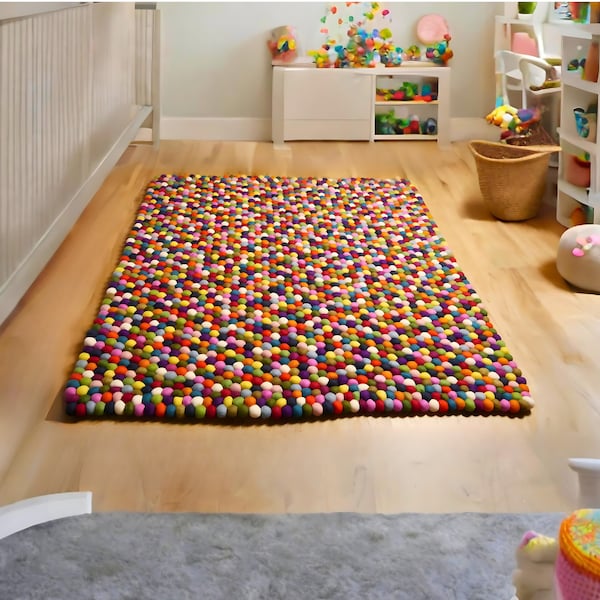 Multi-colored hand-sewn rectangular rug made of wool felt balls