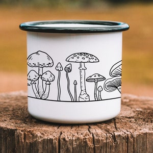 May include: White enamel mug with a black outline of various mushrooms. The mug has a black rim and handle.