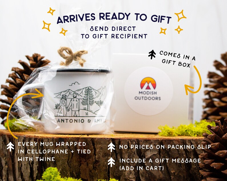 May include: A white enamel mug with a black rim, featuring a mountain scene and the names "ANTONIO & AMY." The mug is wrapped in cellophane and tied with twine, presented in a gift box with the "MODISH OUTDOORS" logo. Text on the image reads "ARRIVES READY TO GIFT."