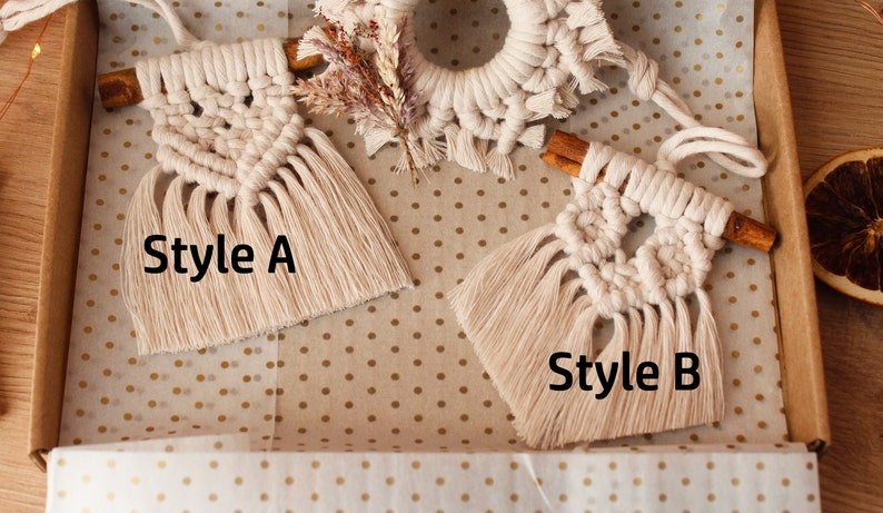 May include: Two handmade macrame ornaments with cinnamon sticks, one with a geometric pattern labeled "Style A" and the other with a circular pattern labeled "Style B".