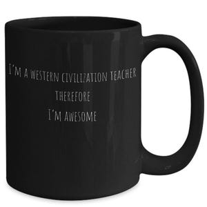 May include: A black ceramic mug featuring white text that reads I'M A WESTERN CIVILIZATION TEACHER THEREFORE I'M AWESOME. The mug has a smooth finish, a cylindrical body, and a curved handle on the right side, providing a simple and functional design.