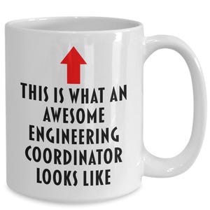 May include: White ceramic coffee mug with a red arrow pointing up and the text "This is what an awesome engineering coordinator looks like".