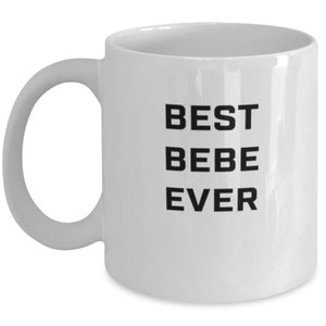 May include: White ceramic coffee mug with black text that reads "BEST BEBE EVER".