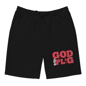 May include: Black shorts with a drawstring waist and pockets. The shorts feature the red text "is the GOD PLG" on the right leg. The shorts are made of a soft material.