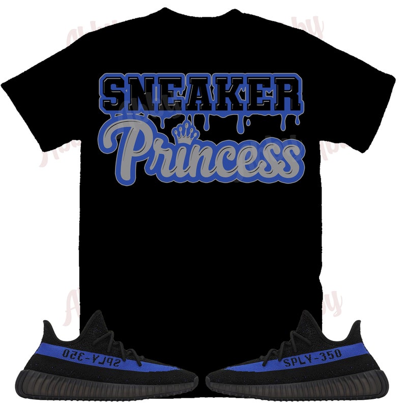 May include: Black t-shirt with blue dripping text that says "Sneaker Princess" and a crown above the word "Princess".  A pair of black and blue sneakers with the text "SPLY-350" on one shoe and "350-Y3J2" on the other shoe.