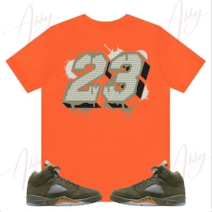 orange and olive green nike shirt