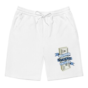 May include: White sweatpants with a blue ribbon and a stack of dollar bills with the text "Blood Sweat Tears" on it.
