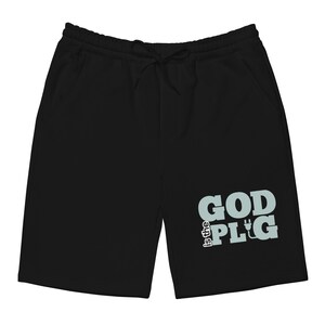 Puede incluir: Shorts negros con cintura con cordón y bolsillos. El texto "is the GOD PLG" está impreso en azul claro en la pierna derecha. Estos shorts son adecuados para uso casual.