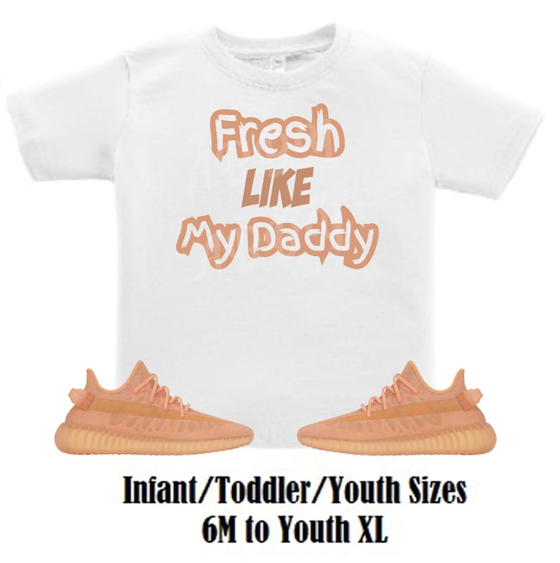 May include: White t-shirt with the text "Fresh Like My Daddy" in peach-coloured letters. The shirt is paired with a pair of peach-coloured trainers. Infant/Toddler/Youth sizes 6M to Youth XL.