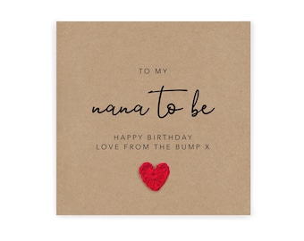 May include: A brown card with the text "To my nana to be Happy birthday Love from the bump x" and a red crocheted heart.
