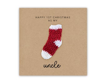 May include: A card with a red and white knitted sock on a brown background. The card says "Happy 1st Christmas as my uncle".